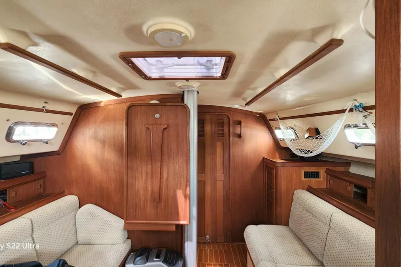 Slide: The Image of Interior of 2000 Island Packet 380 sailboat with wooden finish and cozy seating. - 10
