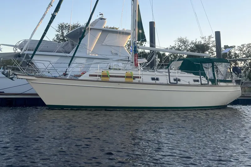 Slide: The Image of Sailboat Island Packet 380, 2000 model, docked in calm waters at sunset. - 2