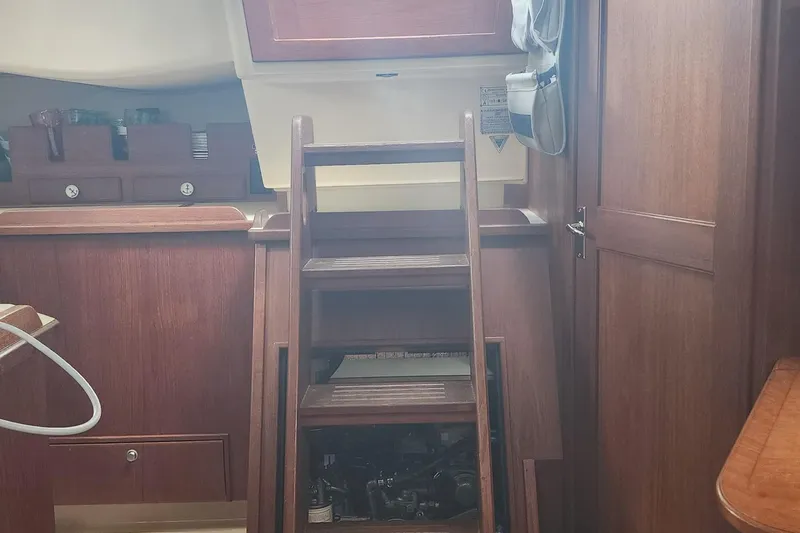 Slide: The Image of Interior of 2000 Island Packet 380 sailboat with wooden steps and cabinetry. - 21