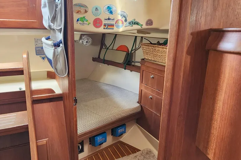Slide: The Image of Cozy cabin interior of 2000 Island Packet 380 sailboat with wooden furnishings and storage. - 23