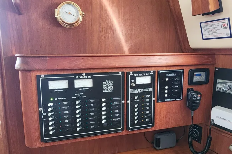 Slide: The Image of Electrical control panel on a 2000 Island Packet 380 yacht, featuring various switches and gauges. - 28