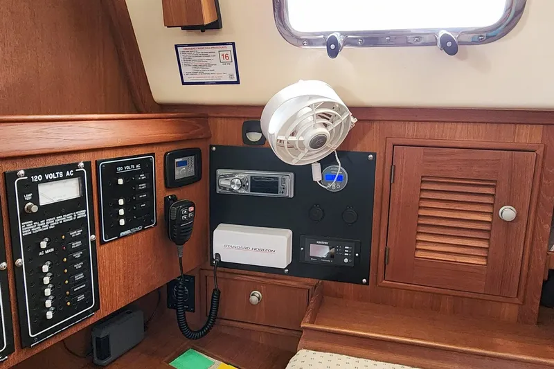 Slide: The Image of Interior of 2000 Island Packet 380 sailboat with control panels and fan. - 29