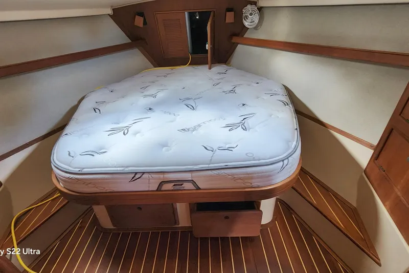 Slide: The Image of Cozy cabin interior of 2000 Island Packet 380 sailboat with comfortable mattress. - 31