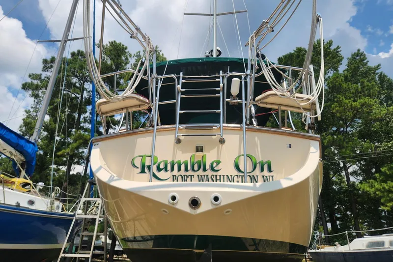 Slide: The Image of Island Packet 380 sailboat from 2000, named "Ramble On," docked in a marina. - 7