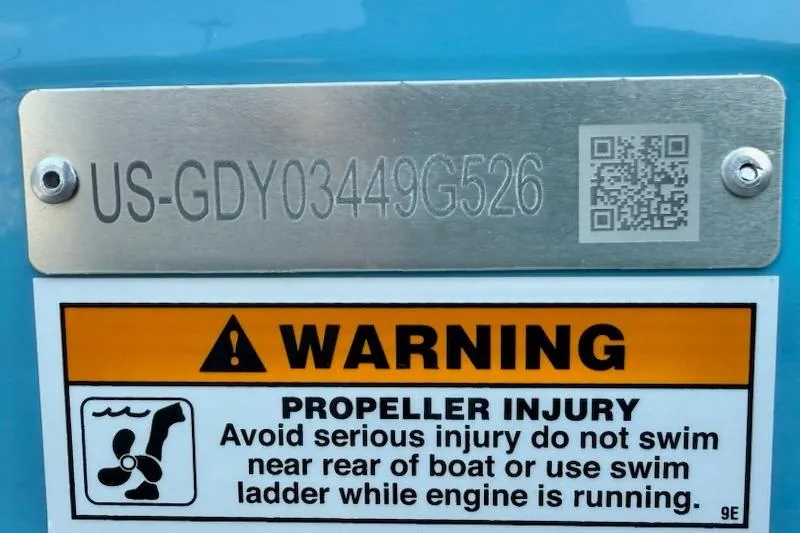 Slide: The Image of Warning label on 2026 Hurricane FD1960RE3-OB boat, cautioning against propeller injury. - 13