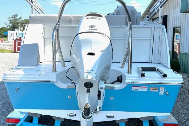 Slide: The Image of 2026 Hurricane FD1960RE3-OB boat, blue and white, rear view with outboard motor. - 3