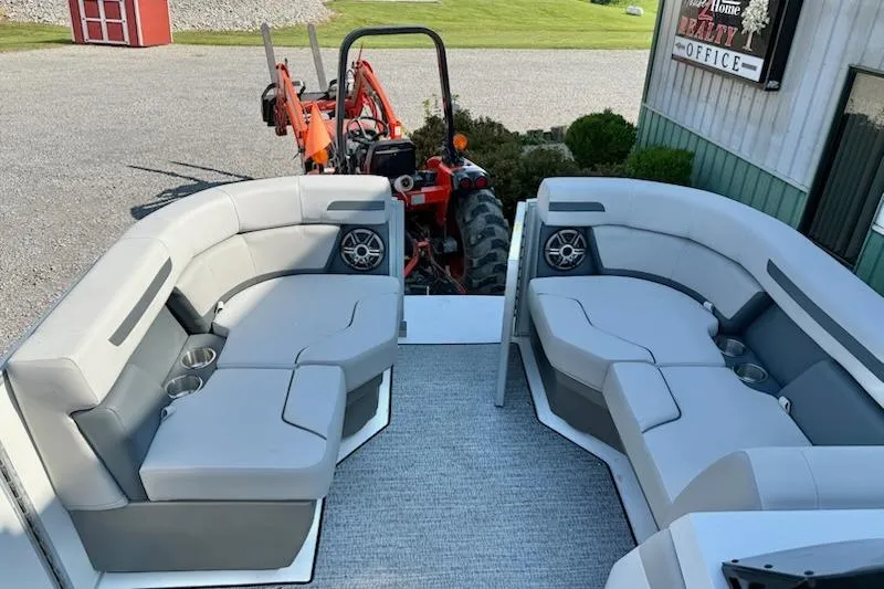 Slide: The Image of Luxurious seating on 2026 Hurricane FD1960RE3-OB boat, with a tractor in the background. - 8