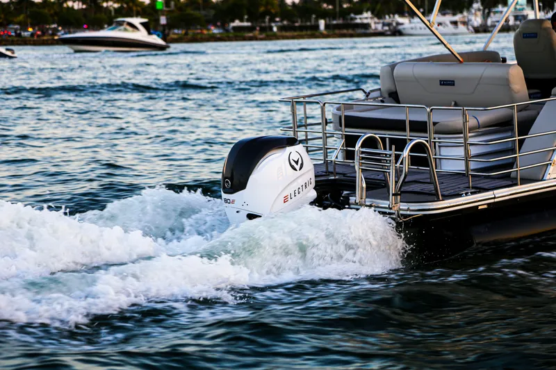 Slide: The Image of Electric Vision Marine Technologies V24 boat cruising on water, showcasing modern design, 2025 model. - 12