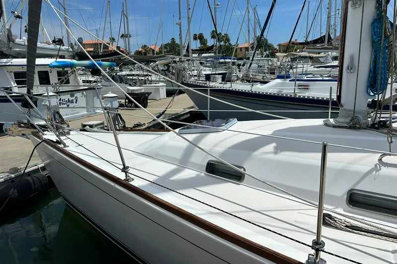 Slide: The Image of 2007 Sabre 386 sailboat docked at marina with other boats in background. - 14