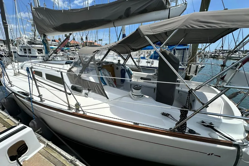Slide: The Image of 2007 Sabre 386 sailboat docked at marina, featuring sleek design and covered cockpit. - 16