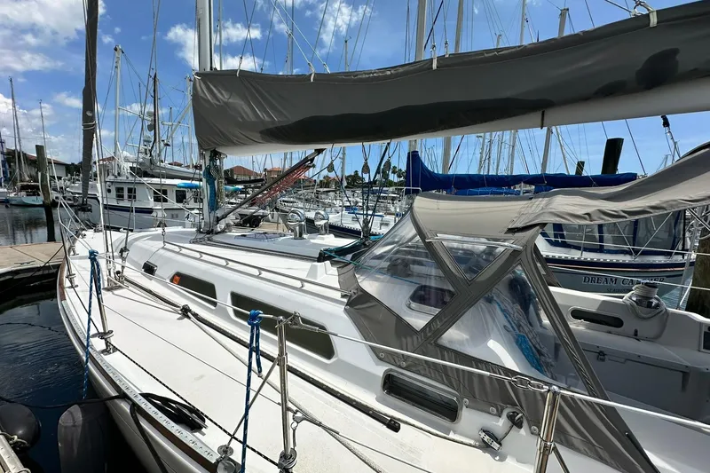 Slide: The Image of 2007 Sabre 386 sailboat docked in a marina under a clear blue sky. - 18