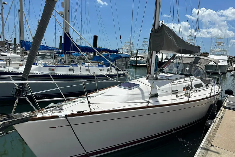Slide: The Image of 2007 Sabre 386 sailboat docked at marina under clear blue sky. - 3