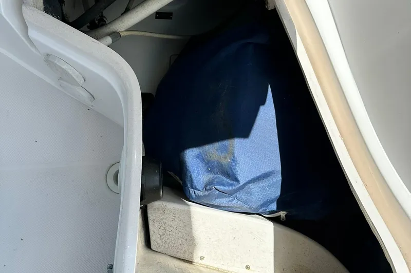 Slide: The Image of Storage compartment in a 2007 Sabre 386 boat, featuring a blue cover. - 37