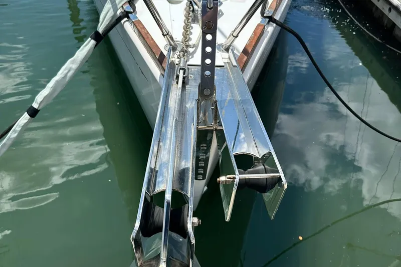Slide: The Image of Bow of 2007 Sabre 386 sailboat with anchor roller, docked in calm water. - 4