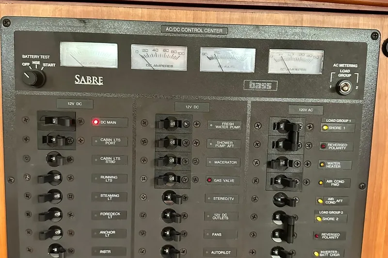 Slide: The Image of Electrical control panel of a 2007 Sabre 386 yacht with various switches and meters. - 45