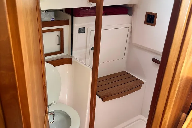Slide: The Image of 2007 Sabre 386 yacht bathroom with wooden accents and compact design. - 46