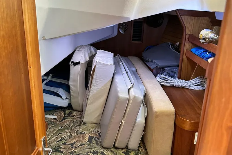 Slide: The Image of Interior storage area of a 2007 Sabre 386 sailboat with cushions and ropes. - 48