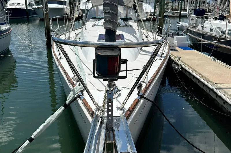 Slide: The Image of Sailboat docked in marina, Sabre 386, 2007 model, with visible bow and rigging. - 5