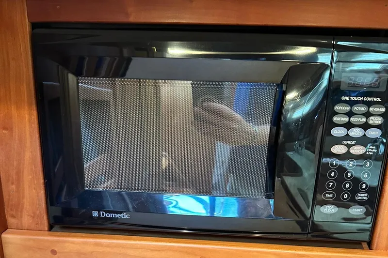 Slide: The Image of Dometic microwave in a Sabre 386 RV, 2007 model, with control panel and wood trim. - 51