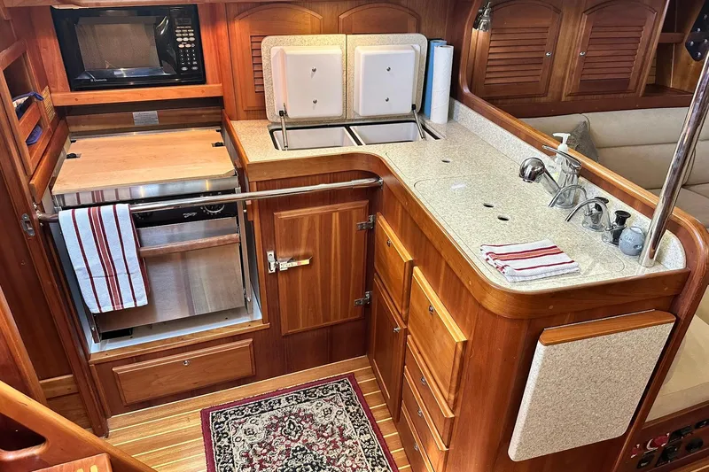 Slide: The Image of Luxurious 2007 Sabre 386 yacht kitchen with wood cabinetry, sink, and appliances. - 54
