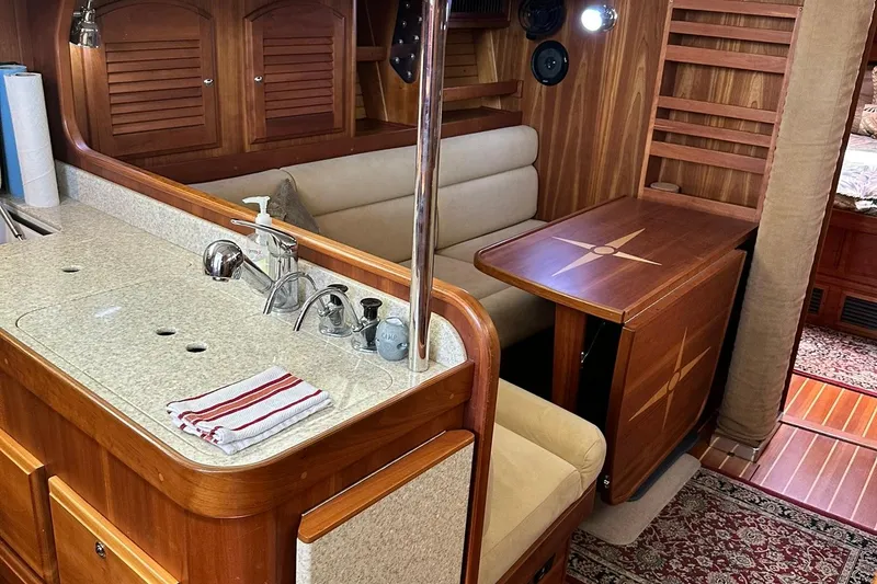 Slide: The Image of Luxurious 2007 Sabre 386 yacht interior with elegant wood finish and cozy seating area. - 56