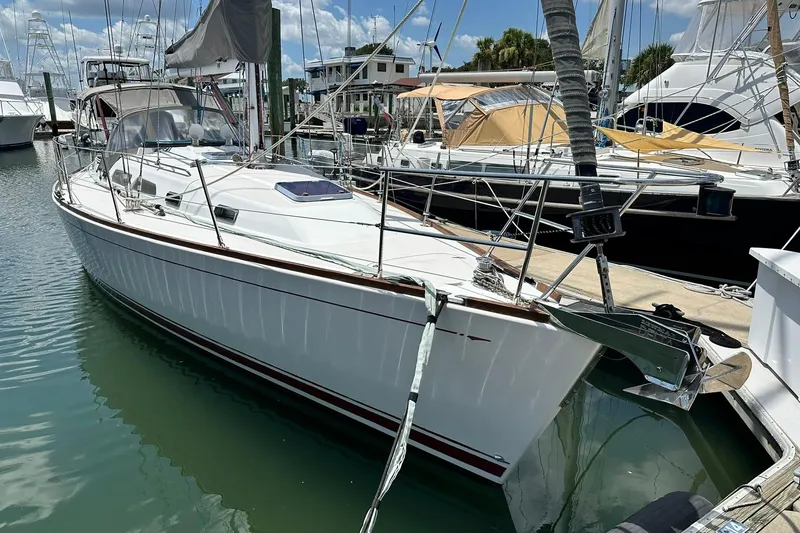 Slide: The Image of 2007 Sabre 386 sailboat docked at marina, featuring sleek white hull and modern design. - 6