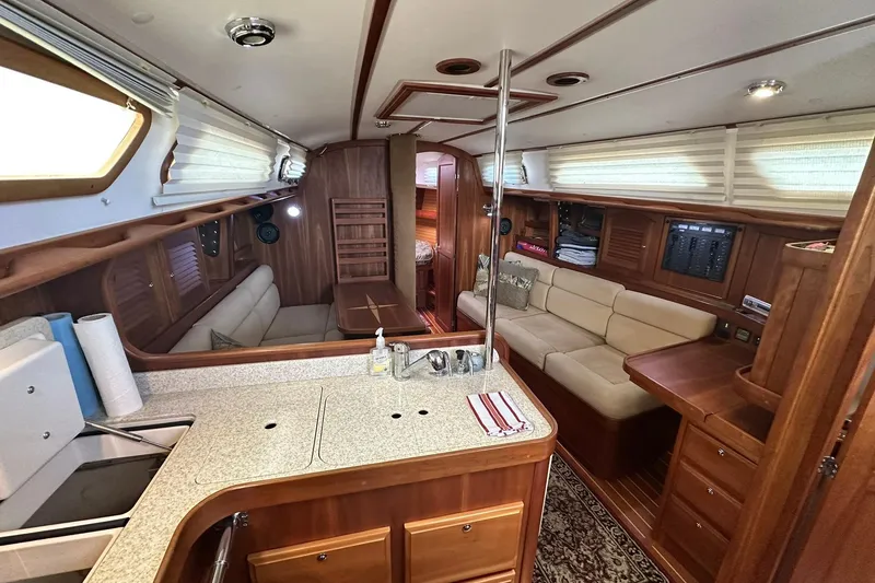Slide: The Image of Luxurious interior of a 2007 Sabre 386 yacht featuring a cozy seating area and kitchenette. - 60