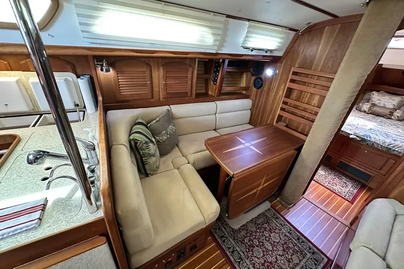 Slide: The Image of Luxurious 2007 Sabre 386 yacht interior with cozy seating, wooden table, and elegant decor. - 61