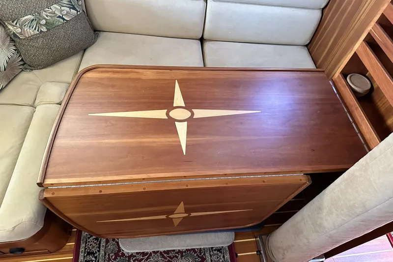 Slide: The Image of Wooden table with compass rose design in a 2007 Sabre 386 yacht interior. - 62