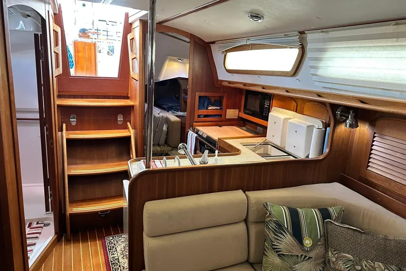 Slide: The Image of Interior of 2007 Sabre 386 sailboat with wooden cabinetry and cozy seating area. - 64