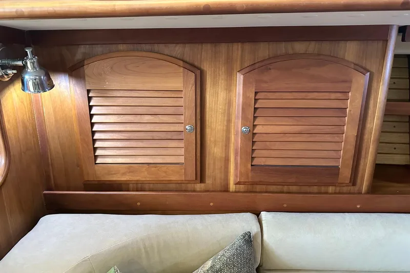Slide: The Image of Wooden interior of a 2007 Sabre 386 yacht with louvered cabinets and a cozy sofa. - 65