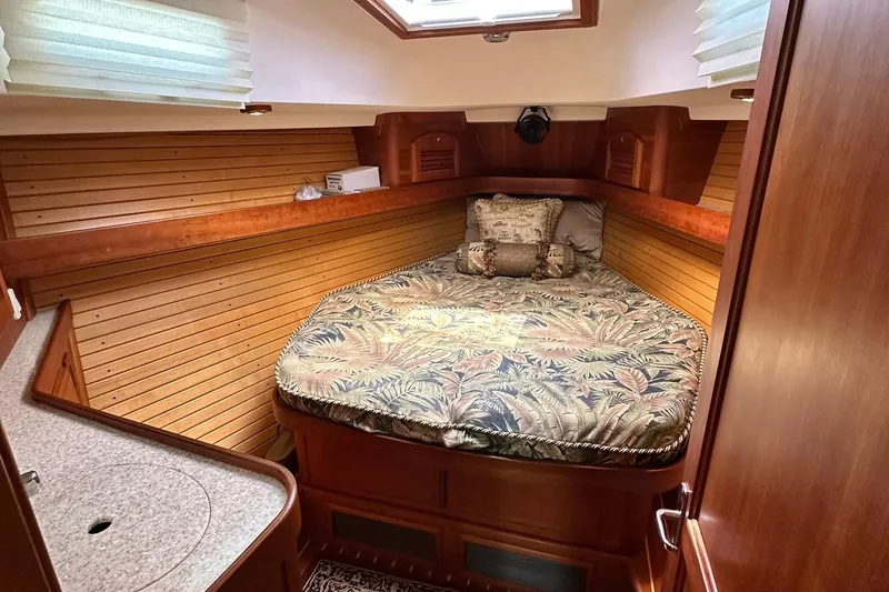 Slide: The Image of Cozy cabin interior of 2007 Sabre 386 yacht with patterned bedding and wooden paneling. - 69