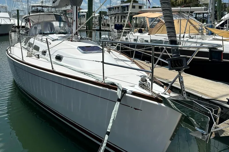 Slide: The Image of 2007 Sabre 386 sailboat docked at marina, featuring sleek white design and modern rigging. - 7