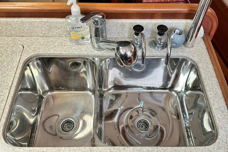 Slide: The Image of Stainless steel double sink with faucet and hand sanitizer on a Sabre 386, 2007 model. - 74