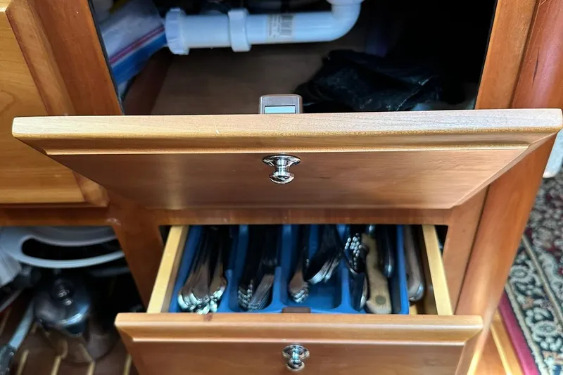 Slide: The Image of Wooden kitchen drawers with utensils, open in a Sabre 386, 2007 model. - 77