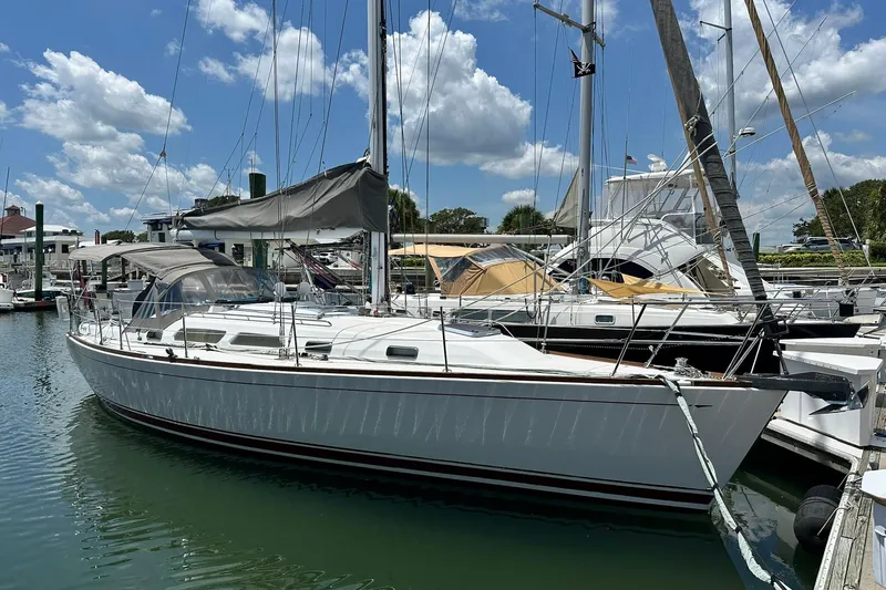 Slide: The Image of 2007 Sabre 386 sailboat docked at marina under blue sky. - 8