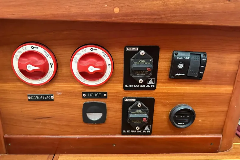 Slide: The Image of Control panel of a 2007 Sabre 386 yacht with switches and circuit breakers. - 80