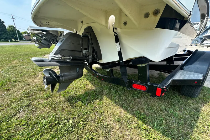 Slide: The Image of 2013 Regal 1900 Bowrider boat on trailer, showing outboard motor and propeller. - 10