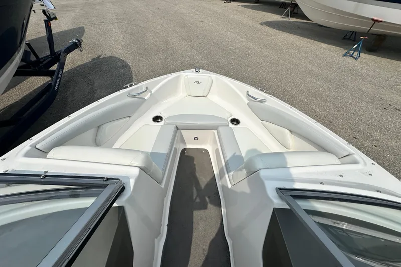Slide: The Image of 2013 Regal 1900 Bowrider boat interior with white seating and open bow design. - 11