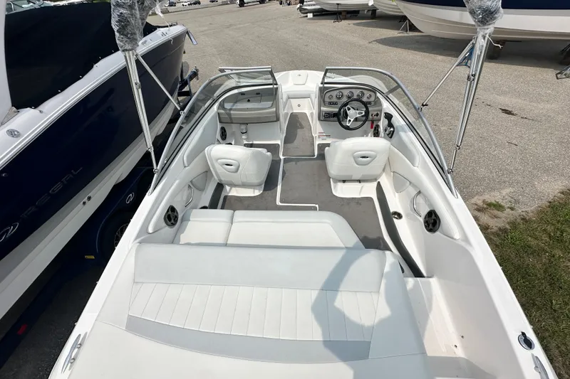 Slide: The Image of 2013 Regal 1900 Bowrider boat interior with seating and steering wheel. - 5