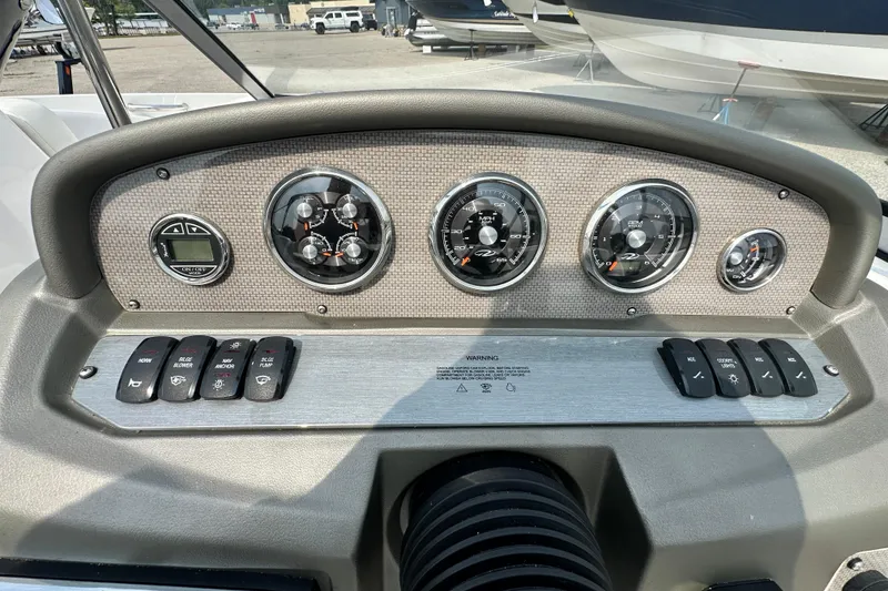 Slide: The Image of Dashboard of a 2013 Regal 1900 Bowrider boat with gauges and control switches. - 7