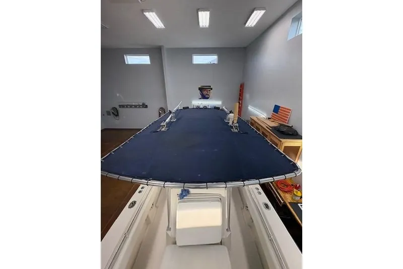 Slide: The Image of 2003 Contender 27 Open boat interior with branded floor mat and control panel. - 10