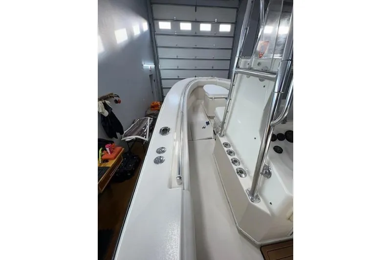 Slide: The Image of 2003 Contender 27 Open boat interior with rod holders and stainless steel railings. - 11