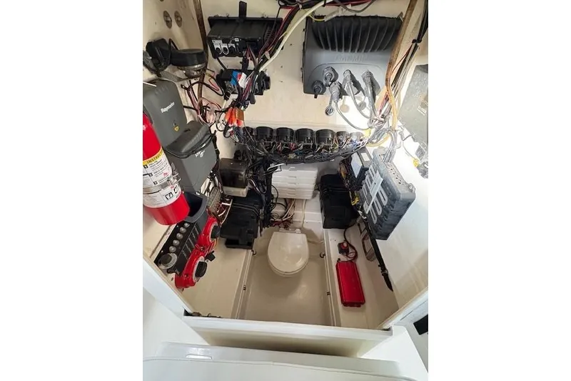 Slide: The Image of Electrical compartment of a 2003 Contender 27 Open boat with wiring and equipment. - 19