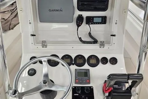 Slide: The Image of 2003 Contender 27 Open boat console with steering wheel and navigation equipment. - 3