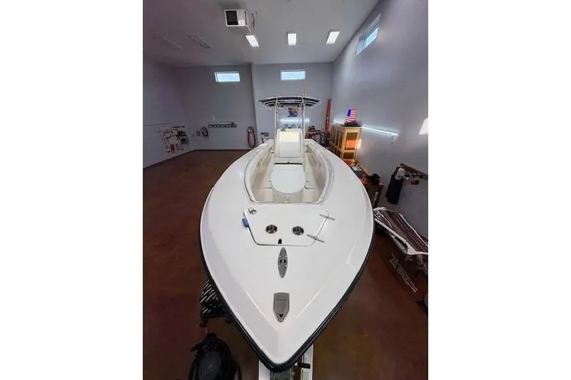 Slide: The Image of 2003 Contender 27 Open boat in indoor storage, on trailer, with yellow hull. - 6