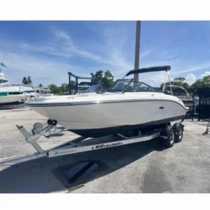 Slide: The Image of 2022 Sea Ray SPX 210 Outboard boat on trailer, parked outdoors under clear sky at a Boateka used boat dealership - 1