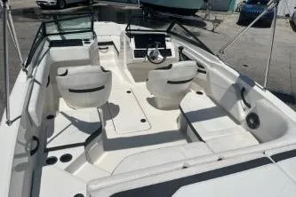 Slide: The Image of 2022 Sea Ray SPX 210 Outboard boat interior with seating and steering console. - 10