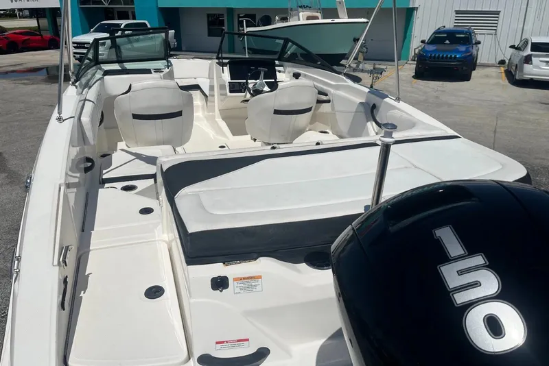 Slide: The Image of 2022 Sea Ray SPX 210 Outboard boat with spacious seating and 150 HP engine. - 11