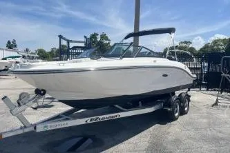 Slide: The Image of 2022 Sea Ray SPX 210 Outboard boat on trailer, parked outdoors under clear sky at a Boateka used boat dealership - 2